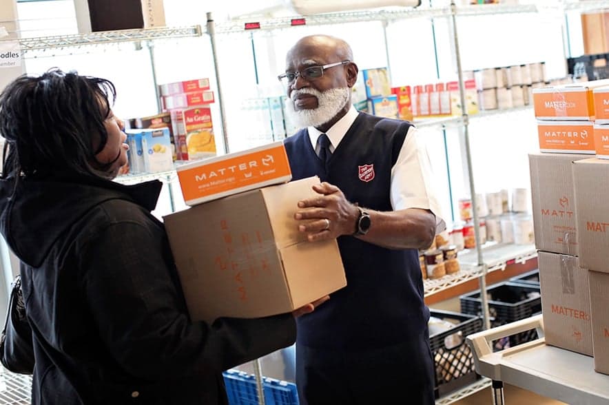 Salvation Army Officer talking and smiling with a community member.